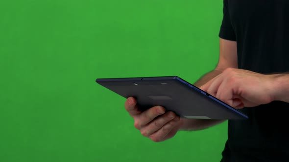 Young Man Works on Tablet - Green Screen - Studio - Closeup