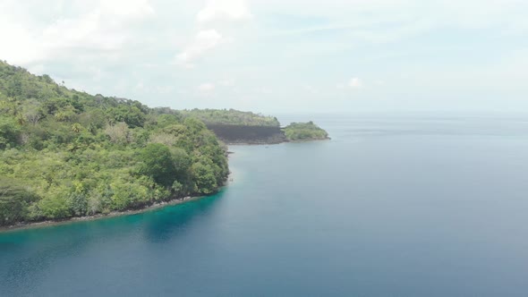 Aerial: flying over Banda Islands active volcano Gunung Api lava flows Indonesia