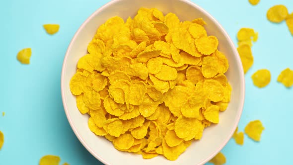 Breakfast Corn Flakes Rotate in a Bowl on the Kitchen Table