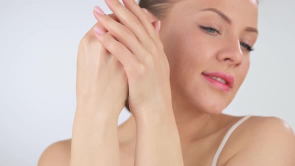 Woman Applying Cosmetic Hand Cream on Hand