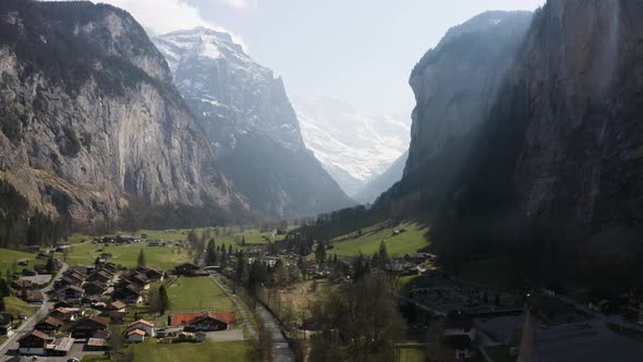 Aerial ascending backwards and shows Lauterbrunnen town, Switzerland