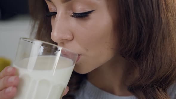 Lovely Joyful Satisfied Woman Drinking a Glass of Milk and Posing on Camera