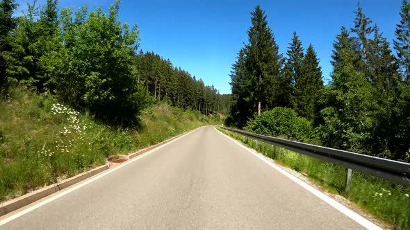 POV Driving on motorcycle on a scenic road in Eifel National Park in Germany