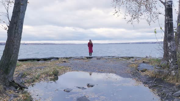 Young Girl Standing Near A Lake