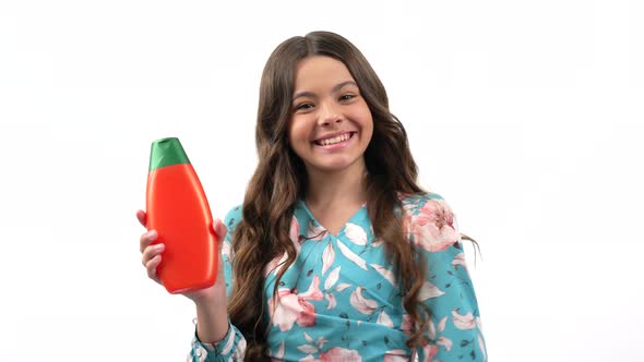 Child Girl Smiling and Turning Hold Hair Silk Bottle Showing Thumb Up Beauty
