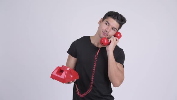 Young Stressed Multi-ethnic Man Talking on Telephone