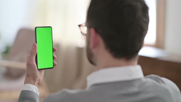 Rear View of Man Using Smartphone with Chroma Key Screen