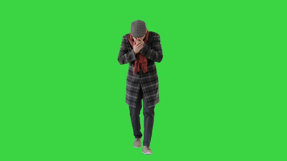 Stylish Gentleman Walking and Coughing on a Green Screen, Chroma Key.