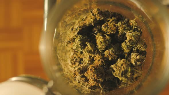 Medical Cannabis Jar of Dried and Treated Marijuana Buds Medical Odorous Cannabis From the Fridge