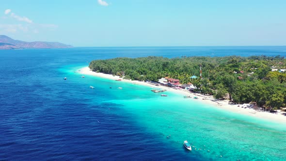 Wide angle flying copy space shot of a white sand paradise beach and blue ocean background in best q