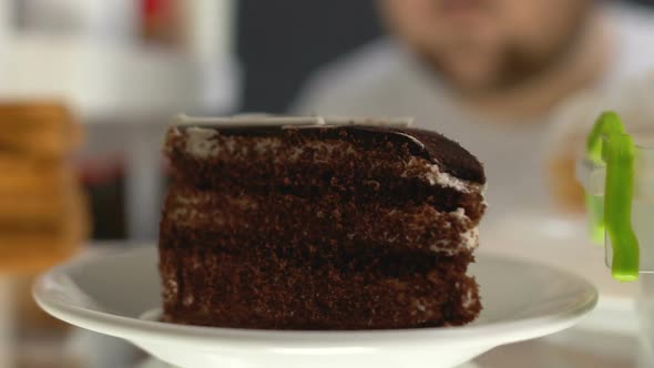 Obese Man Taking Chocolate Cake Plate From Fridge, High Sugar Dessert Diabetes