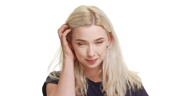 Shy Coy Blonde Caucasian Teenage Girl Standing Smiling on White Background in Slowmotion