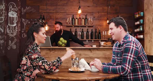 Zoom in Shot of Beautiful Couple Drinking Coffee in Vintage Rustic Coffee Shop Pub Restaurant