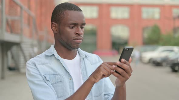 Outdoor African Man Using Smartphone