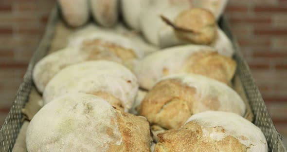 Tray Of Freshly Baked Bread Buns In A Bakery - close up, tilt down