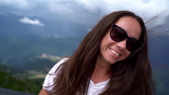 Selfie Portrait of Happy Woman at Top of Mount, She Is Smiling, Long Hair Are Swaying