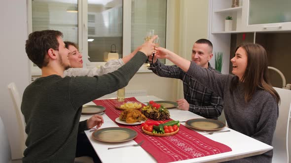 Big Family Celebration in Christmas Day Two Young Couple Have a Meal Smiling