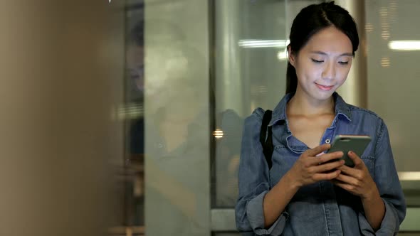 Window reflection of business woman use of smart phone 