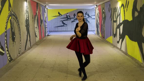 Stunning looking dancer dances in the underground passage