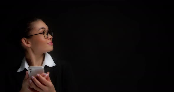 Woman Looks at an Copy Space on the Right While Texting on Her Phone