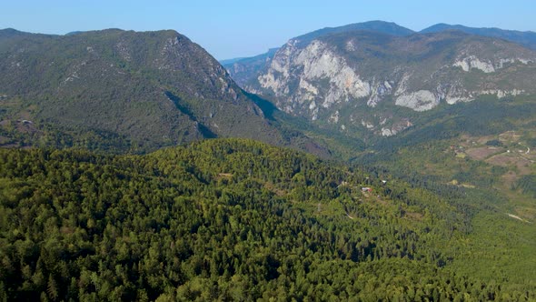 steep green mountains, deep forest and mountain road, beautiful valley  