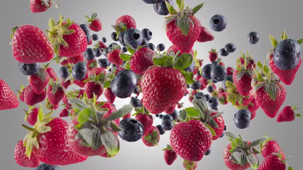 Burst of Strawberry Blueberry in Grey Background