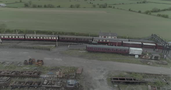 Aerial orbital above stationary steam train in train station