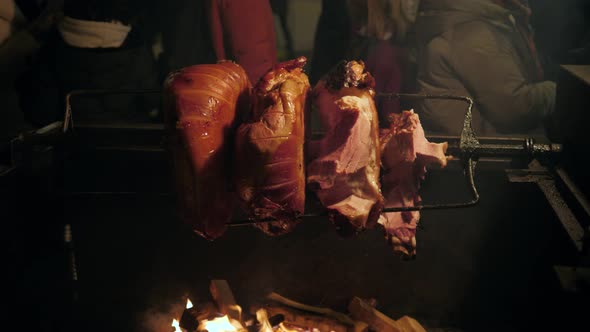 Big Piece of Meat Coocked on Open Fire and Some Pork Pieces Grilled at Historical Medieval Festival