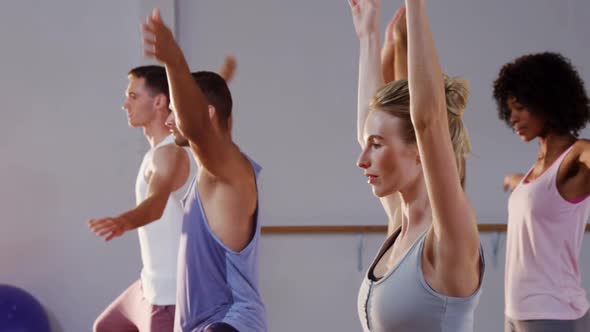 Group of people Practicing yoga in fitness studio