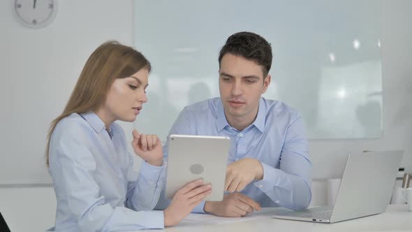 Business Colleagues Using Tablet in Office Business Plan