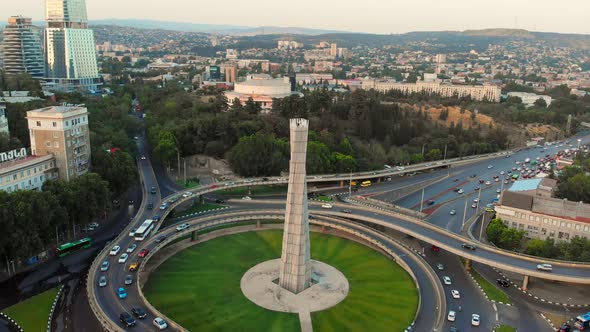 Vehicles In Traffic With Tbilisi City Panorama