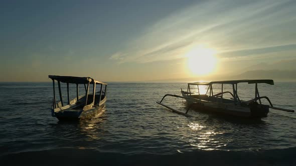 Fishing and Tour Boats Moored to a Shore During Sunrise