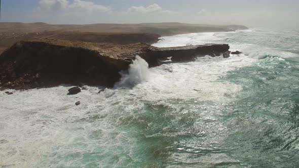 Aerial view of waves crashing of the rocks of punta Guadalupe in Fuerteventura.