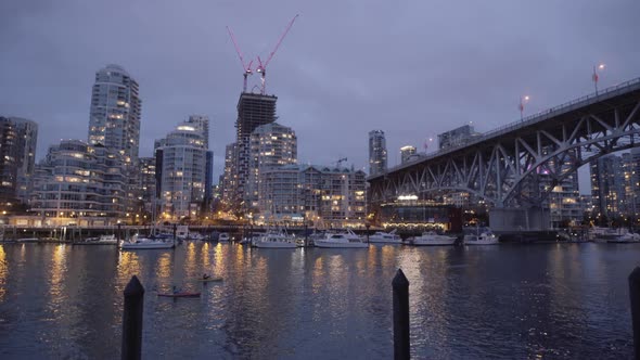 Two kayakers near Yaletown shoot from Granville Island at Night