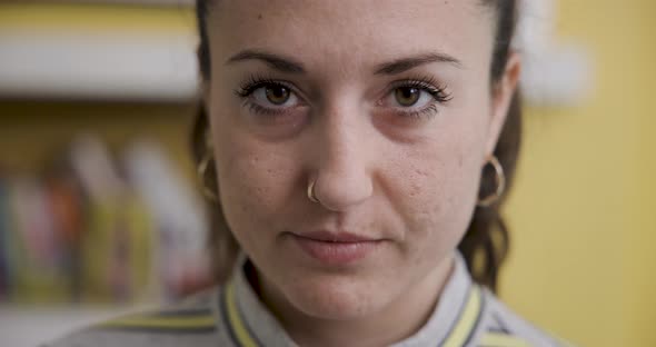 Portrait of young woman at home smiling and looking at camera