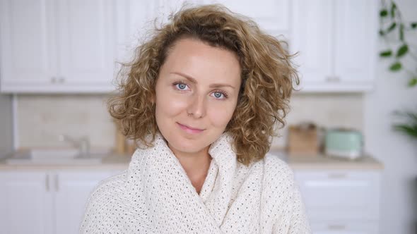 Portrait Of Happy Woman Looking At Camera At Home