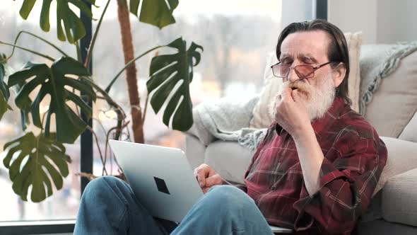 Modern Senior Man Working on Laptop at Home