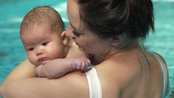 Mother Kiss Baby in the Pool