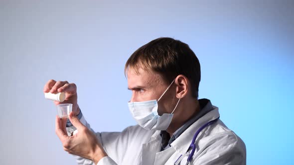 Doctor Protective Mask Pours Pills From Bottle