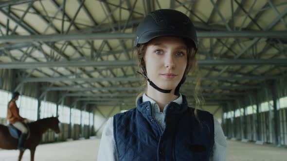 Portrait of Female Jockey in Riding Arena