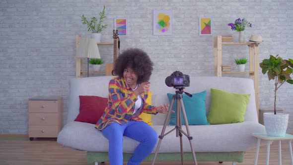 African Woman Blogger with an Afro Hairstyle Before the Camera
