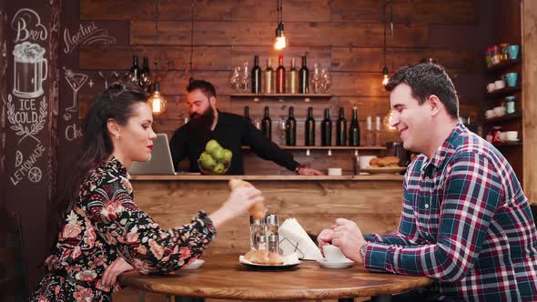 Zoom in Shot of Beautiful Couple Drinking Coffee in Vintage Rustic Coffee Shop Pub Restaurant