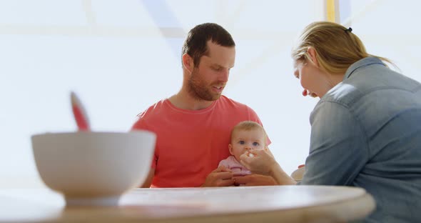 Parents feeding their baby boy 4k