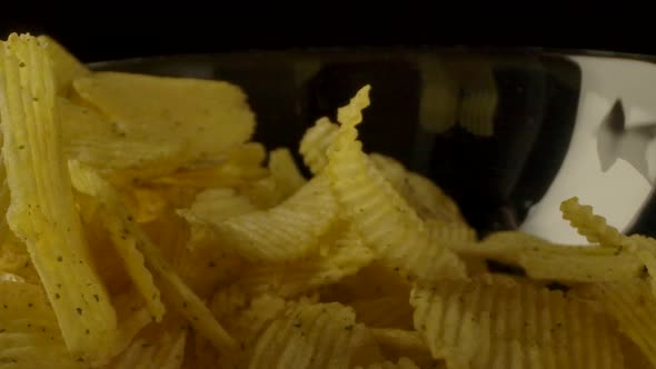 Ribbed Chips Falling Into Bowl