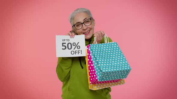 Senior Granny Woman Showing Shopping Bags and Up To 50 Percent Off Inscriptions Banner Black Friday