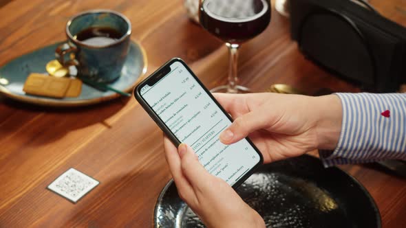 Woman Using Online Menu in Cafe Scanning Qr Code with Smartphone in Restaurant