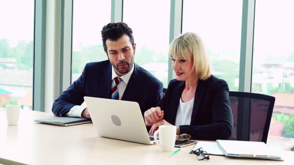 Two Happy Business People Celebrate at Office