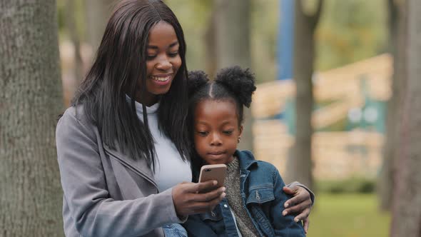 African Family Young Mother Afro American Mommy Mum with Daughter Cute Little Girl Child Kid Sitting