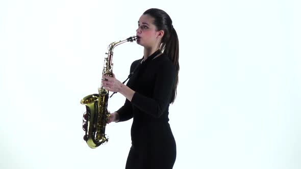 Woman in Black Dress Plays on Saxophone Melody. Slow Motion