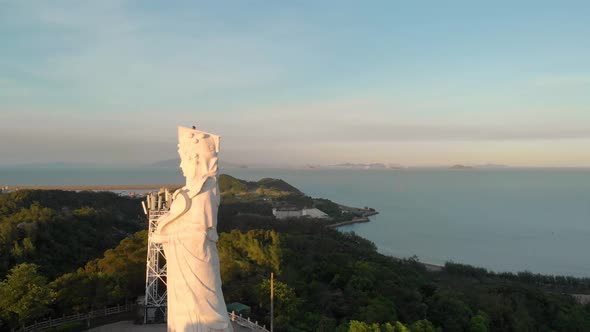 Aerial rotating around famous A-Ma Statue in Coloane, Macau